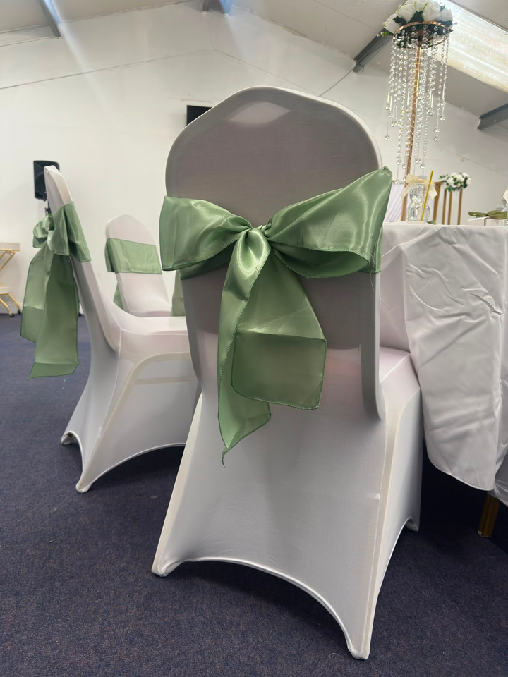 Chair styled with sage green sash and bow