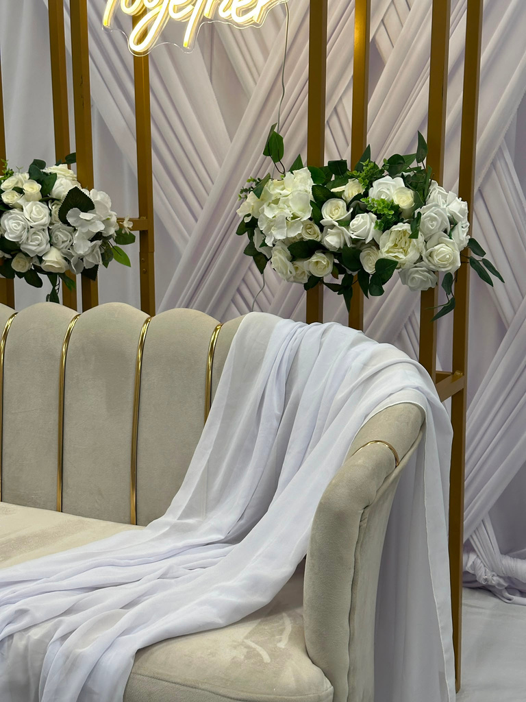Loveseat styled with white draping