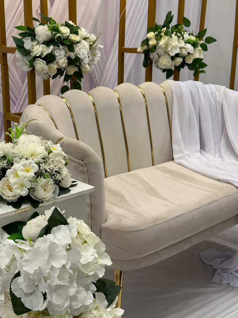 Velvet sofa styled with floral arrangements